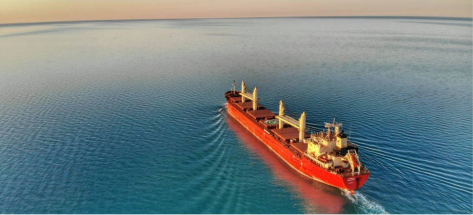 person holding pencil near laptop computer